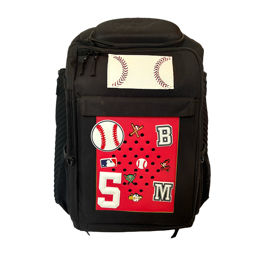 A black DRIP Batpack with a customizable front panel featuring baseball-themed patches and a signature patch with 'DRIP Athletics' written on it.