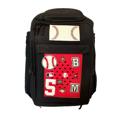 A black DRIP Batpack with a customizable front panel featuring baseball-themed patches and a signature patch with 'DRIP Athletics' written on it.